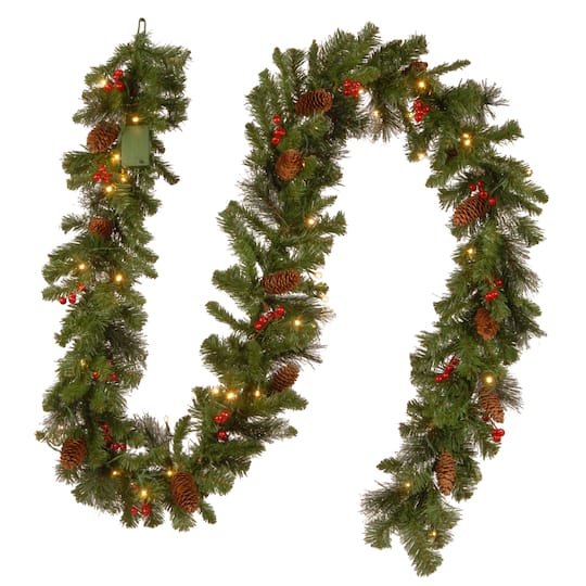 9' x 10" Pre-lit Crestwood® Spruce Artificial Christmas Garland W/ Silver Bristle, Cones, Red Berries, Glitter W/ 50 Battery Operated Soft White LED